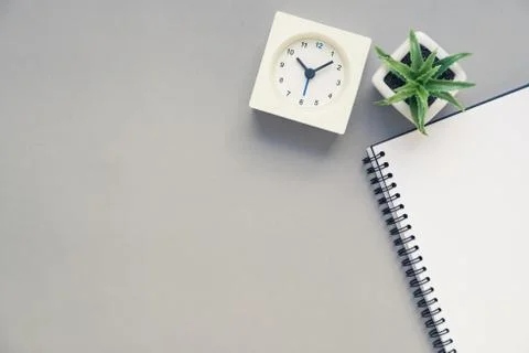 Table top view of office desk with clock Stock Photos