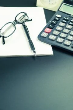 Table top view of pen, notebook and calculator on office desk Stock Photos