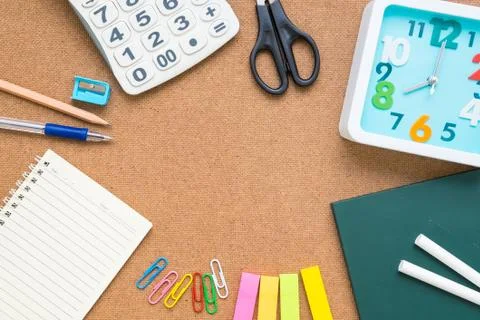 Table top view of stationery items on brown background Stock Photos