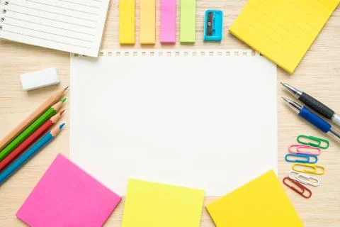 Table top view of stationery items  with empty line paper on wooden desk Stock Photos