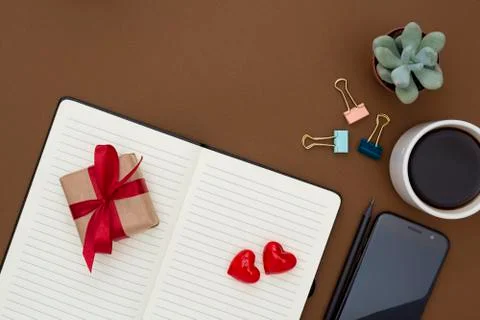 Table top of work space. Valentine's Day concept. Open notebook, pencil, cup  Stock Photos