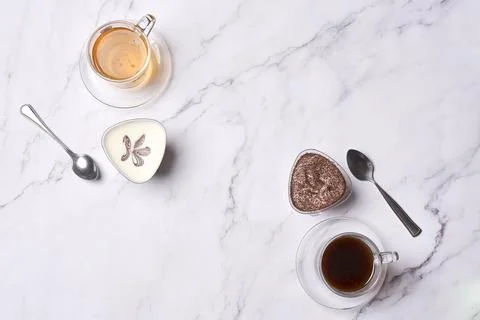 A table topped with cups of coffee and chocolate cake Stock Photos