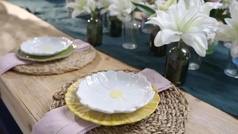 A table with two white plates and two napkins on a wooden table Stock Footage 297774427