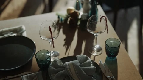 A table with two wine glasses and a bowl of fruit Stock Footage 295993807