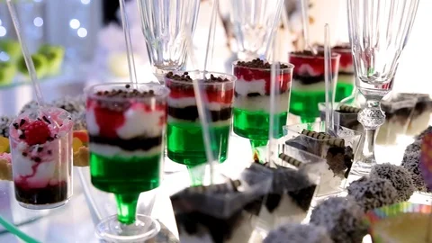 Table with various cookies, tarts, cakes, cupcakes and cakepops. Buffet table Stock Footage 106450239