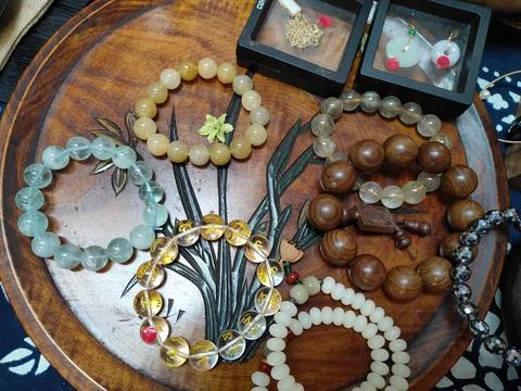 A table with various necklaces and bracelets made of wooden beads, jade sto.. Stock Photos