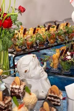 Table with various snacks and salads catering at the event Stock Photos