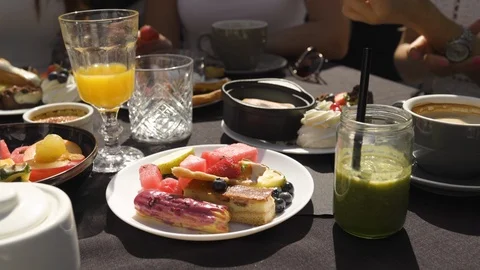 Table view with food and hands: Group of friends in white having breakfast in Stock-Footage 114318126