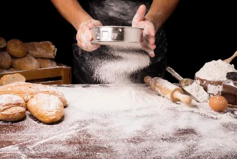 The table was full of bread flour And equipment for making bread And the chef Foto stock