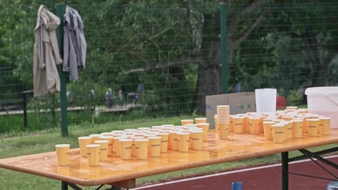 Table with water cups for marathon runners, water distribution point Stock Footage 219929785