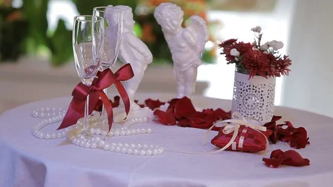 Table for the wedding ceremony with glasses and figurines of angels. Stock Footage 75538491