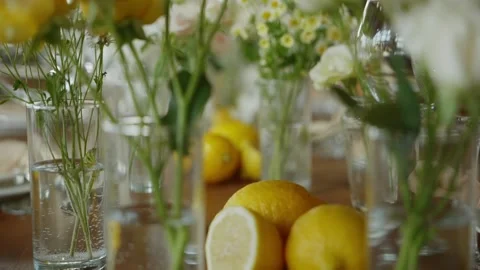 The table at the wedding dinner, which is decorated with real lemons cut in half Stock Footage 258946310
