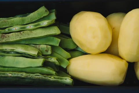 Table where beans and potatoes are being prepared. Stock Photos