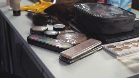 A table on which lies a large number of cosmetics. eye shadow, pout, lipstick Stock Footage 83782069