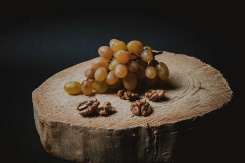 Table white grapes and walnuts on wooden table Stock Photos