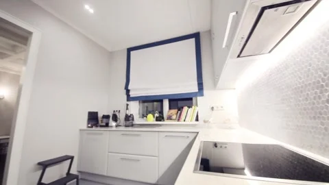 Table in white kitchen with built-in stove in apartment Stock Footage 276364439