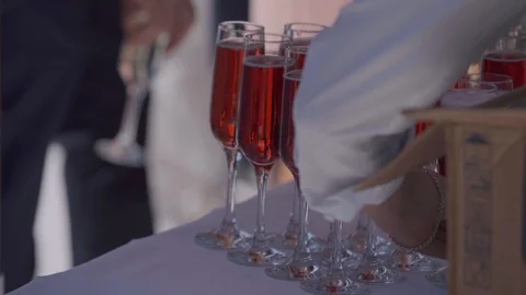 On the table with a white tablecloth there are glasses with a pink drink Stock Footage 103395353