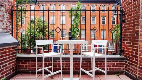 Table with wine on balcony Stock Photos