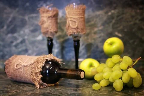 Table with wine bottle grape various vintage elements on old worn backgrou... Stock Photos