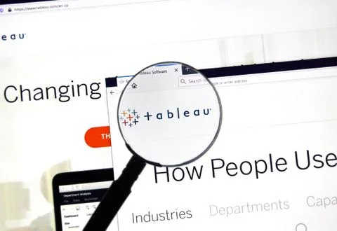 Tableau software official web site and logo under magnifying glass. Stock Photos