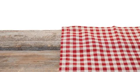 Tablecloth with checkered pattern on wooden table against white background Stock Photos