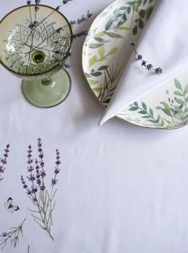 Tablecloth with lavender print and serving plate with napkin Stock Photos