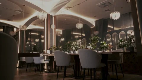 Tables and chairs in the interior space of an expensive restaurant at night Stock Footage 315231768