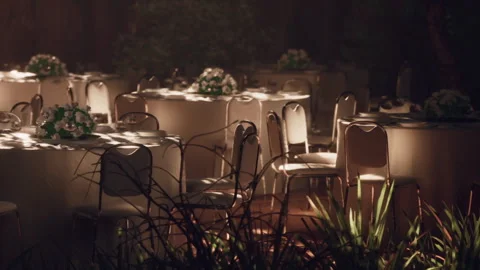 Tables and chairs set up for an event in an outdoor garden setting Stock Footage 344099293