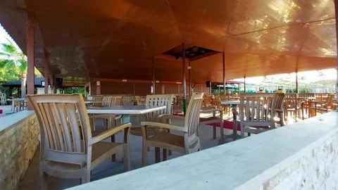 Tables and chairs stand in a cafe bar on the street on holiday in Turkey against Stock Footage 303621516