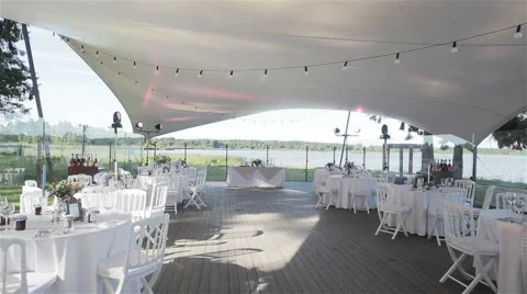 Tables are set and ready for the wedding party in an outdoor restaurant Stock Footage 59108629