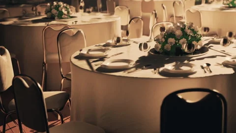 Tables are set for a formal dinner at a banquet hall before the event starts Stock Footage 344380742