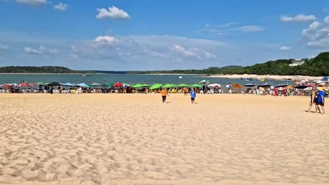 Tables of bars standing in the water at the beach in Alter do Chao, Brazil Stock Footage 304994473