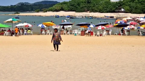 Tables of bars standing in the water at the beach in Alter do Chao, Brazil Stock Footage 304996589