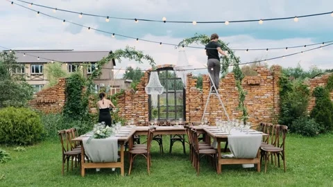 Tables decorated for a wedding reception, served with beautiful glasses and plat Stock Footage 309496432