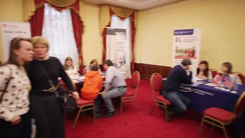 Tables of differernt colleges at exhibition Students International Education Stock Footage 276364722