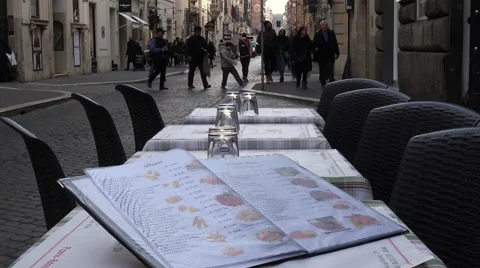 Tables outside the restaurant: tables on the sidewalk with menus on them Video stock 64950820