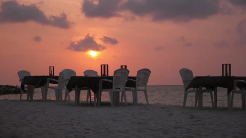 Tables for romantic dinner on the beach, sunset, Maldives Stock Footage 183023168