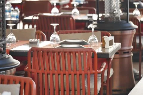 Tables set for dining in a restaurant during daytime Stock Photos