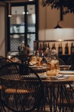 Tables set inside a restaurant, shallow focus. Stock Photos