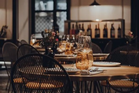 Tables set inside a restaurant, shallow focus. Stock Photos