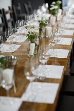 Tables setting at a luxury wedding. Table for guests. Dishes and drinks. Floral Stock Photos