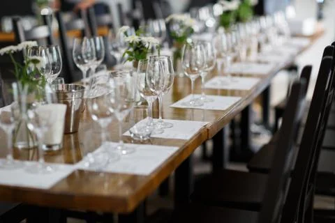 Tables setting at a luxury wedding. Table for guests. Dishes and drinks. Floral Stock Photos