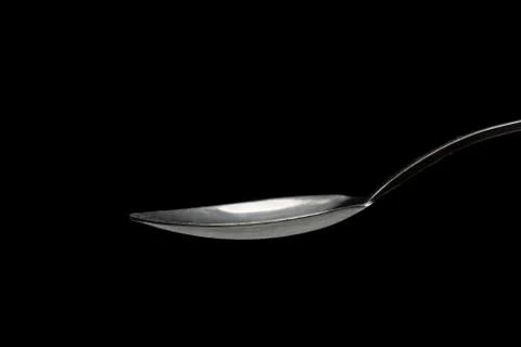 Tablespoon on black background close-up Foto stock