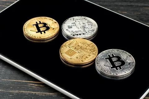 Tablet and bitcoins Stock Photos