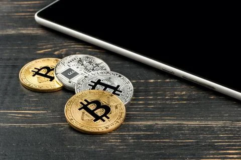 Tablet and bitcoins Stock Photos