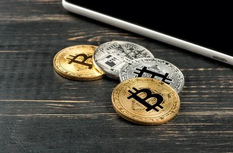 Tablet and bitcoins Stock Photos