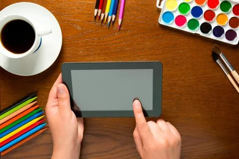 Tablet and drawing tools on the table and hands Stock Photos