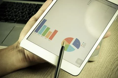 Tablet and graphs Stock Photos