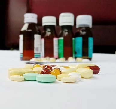 Tablet and liquid medication Stock Photos