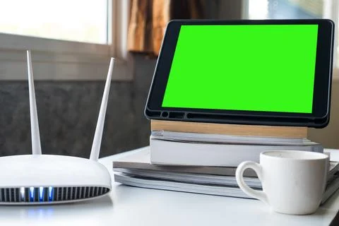 Tablet and router wireless on the table at home. Stock Photos